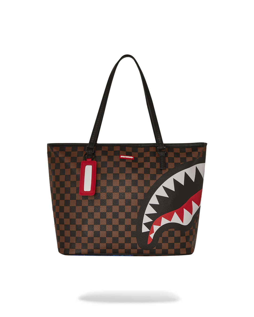 Front view of pink Sprayground tote bag glowing at night