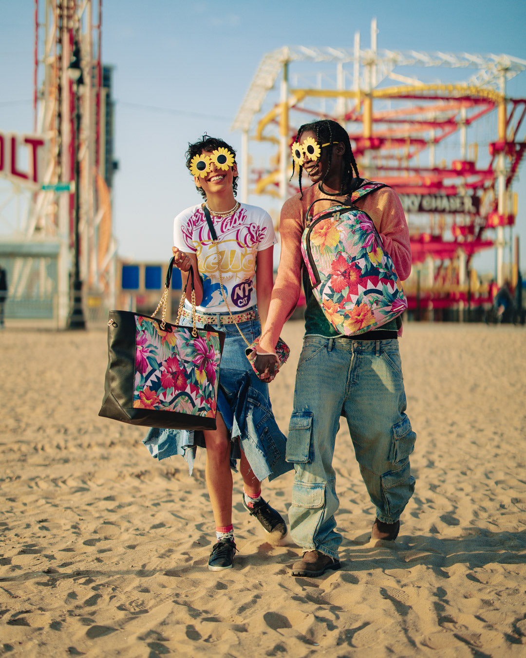 Front view of Sprayground shark-print faux leather tote bag on a city sidewalk