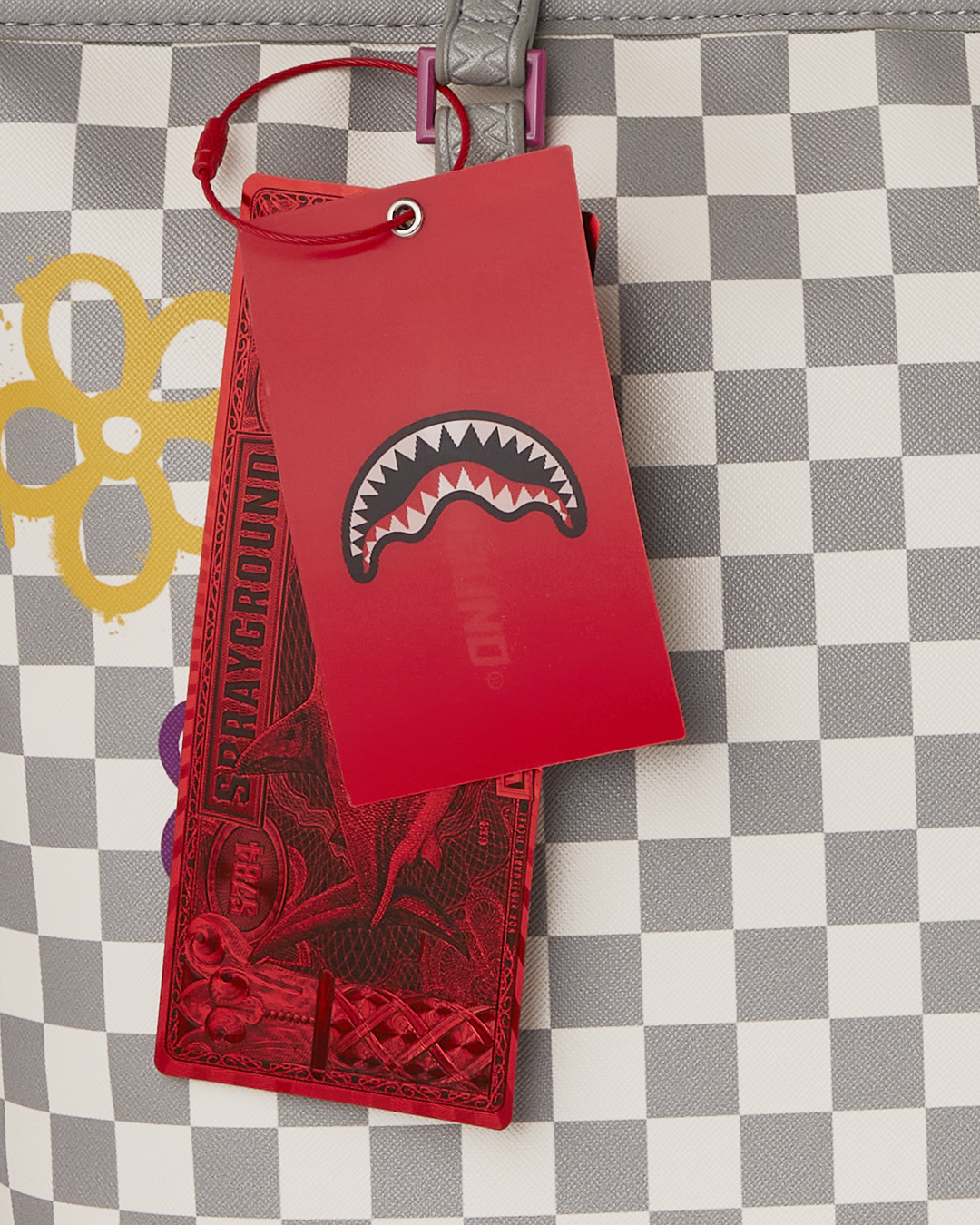 Sprayground Printed Tote Shoulder Bag in use, showcasing its durable faux leather and printed art studio design.