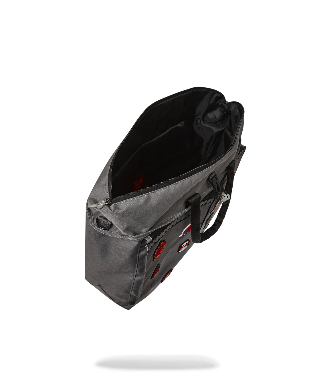 Front view of the designer tote showing rubber patches and airplane zipper detail