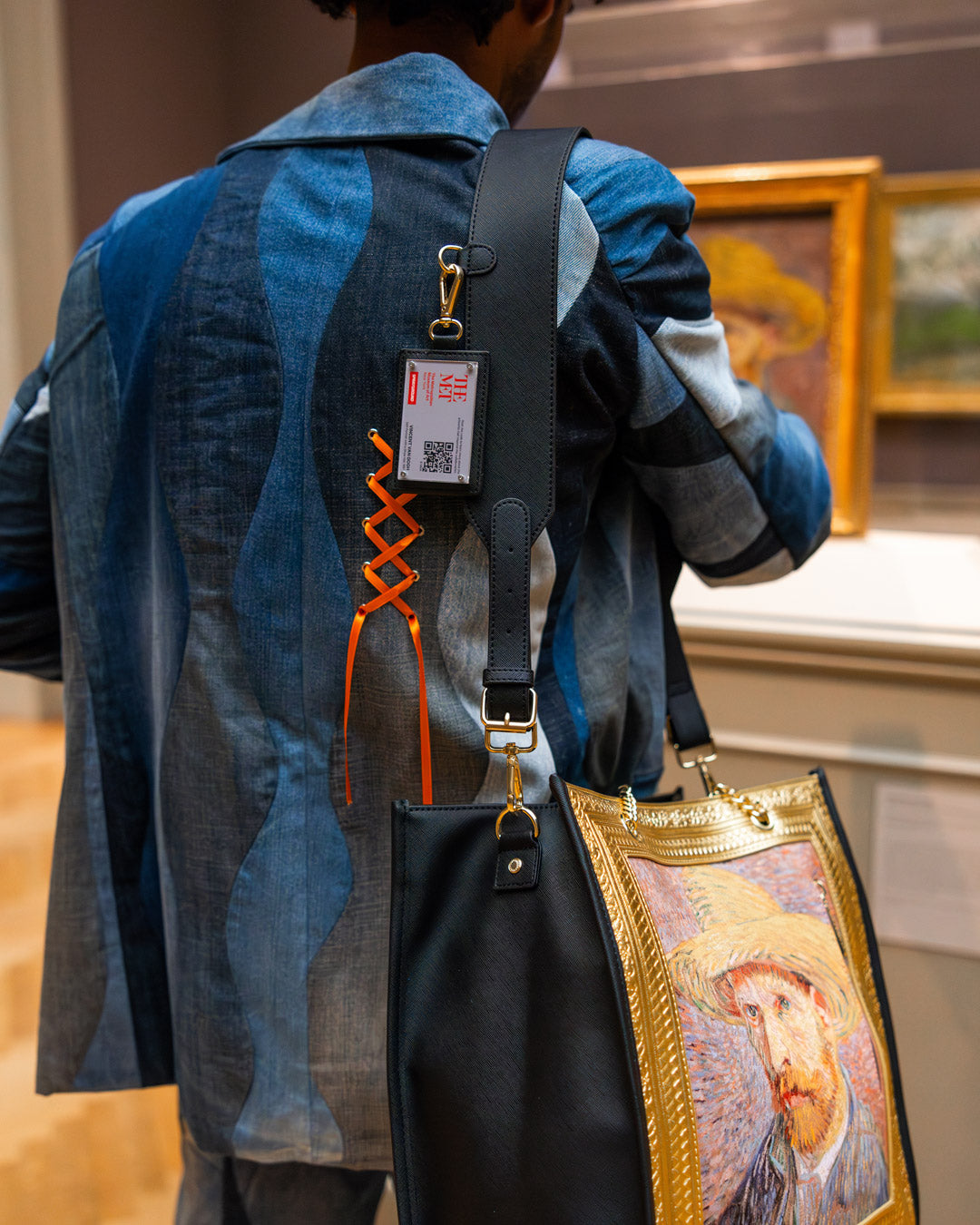 Detailed view of the Van Gogh self-portrait tote bag with gold chain handles.