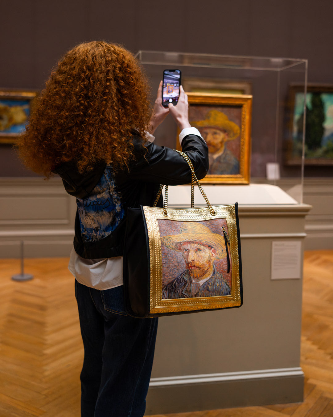 Detailed view of the Van Gogh self-portrait tote bag with gold chain handles.