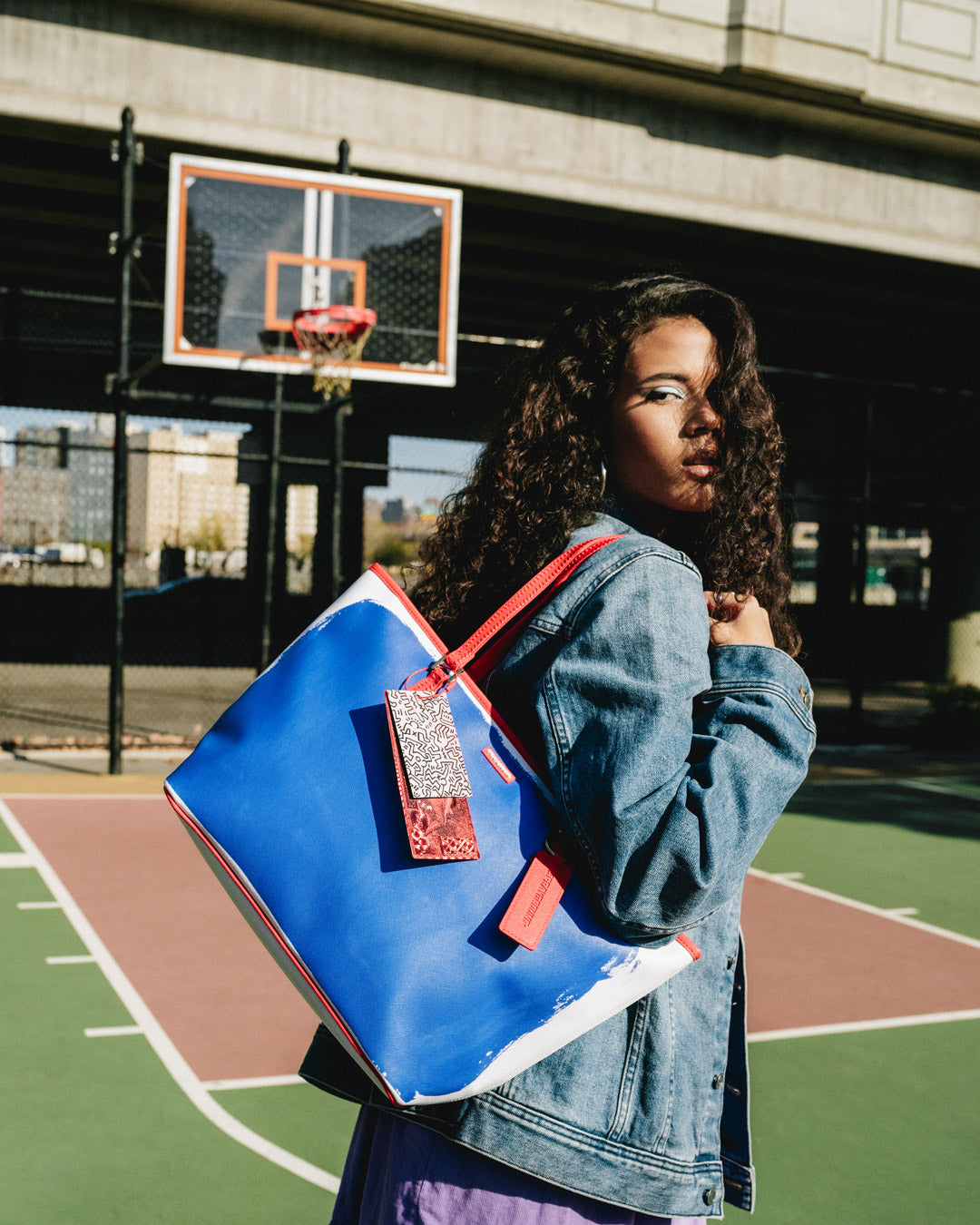 Sprayground Keith Haring Art Tote Bag open, showing interior organizer pocket
