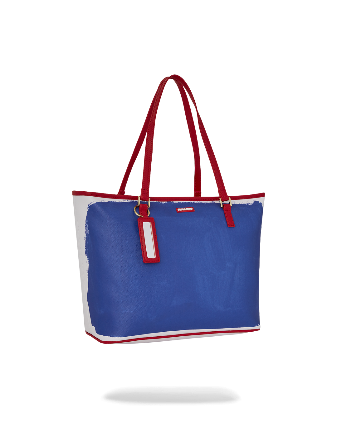 Sprayground Tote Bag with Keith Haring art, being carried over the shoulder