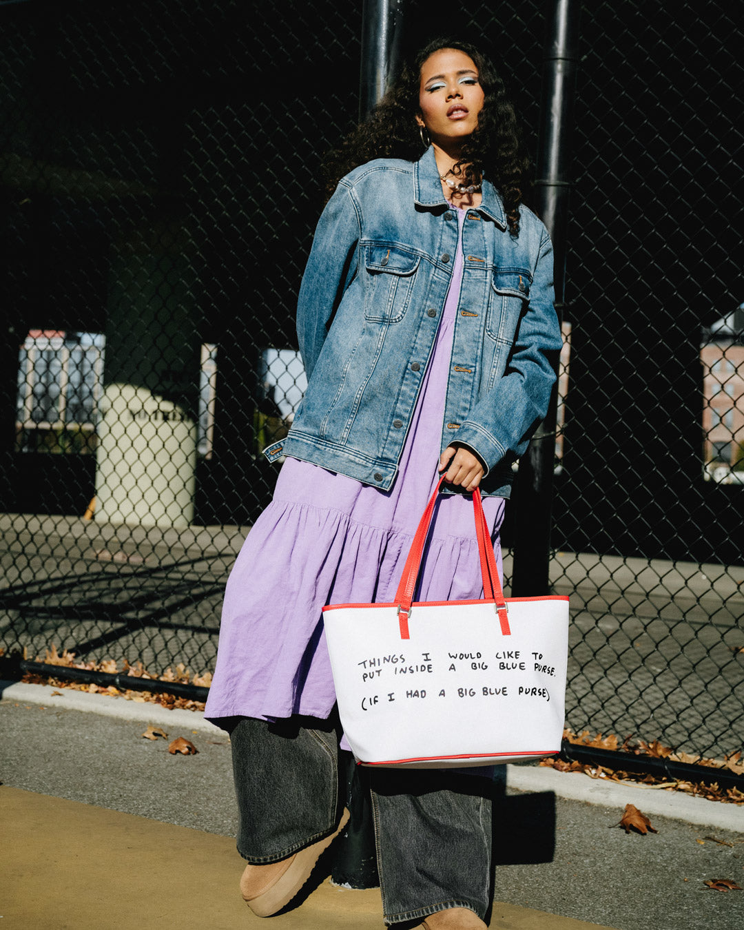 Sprayground Tote Bag with Keith Haring art, being carried over the shoulder