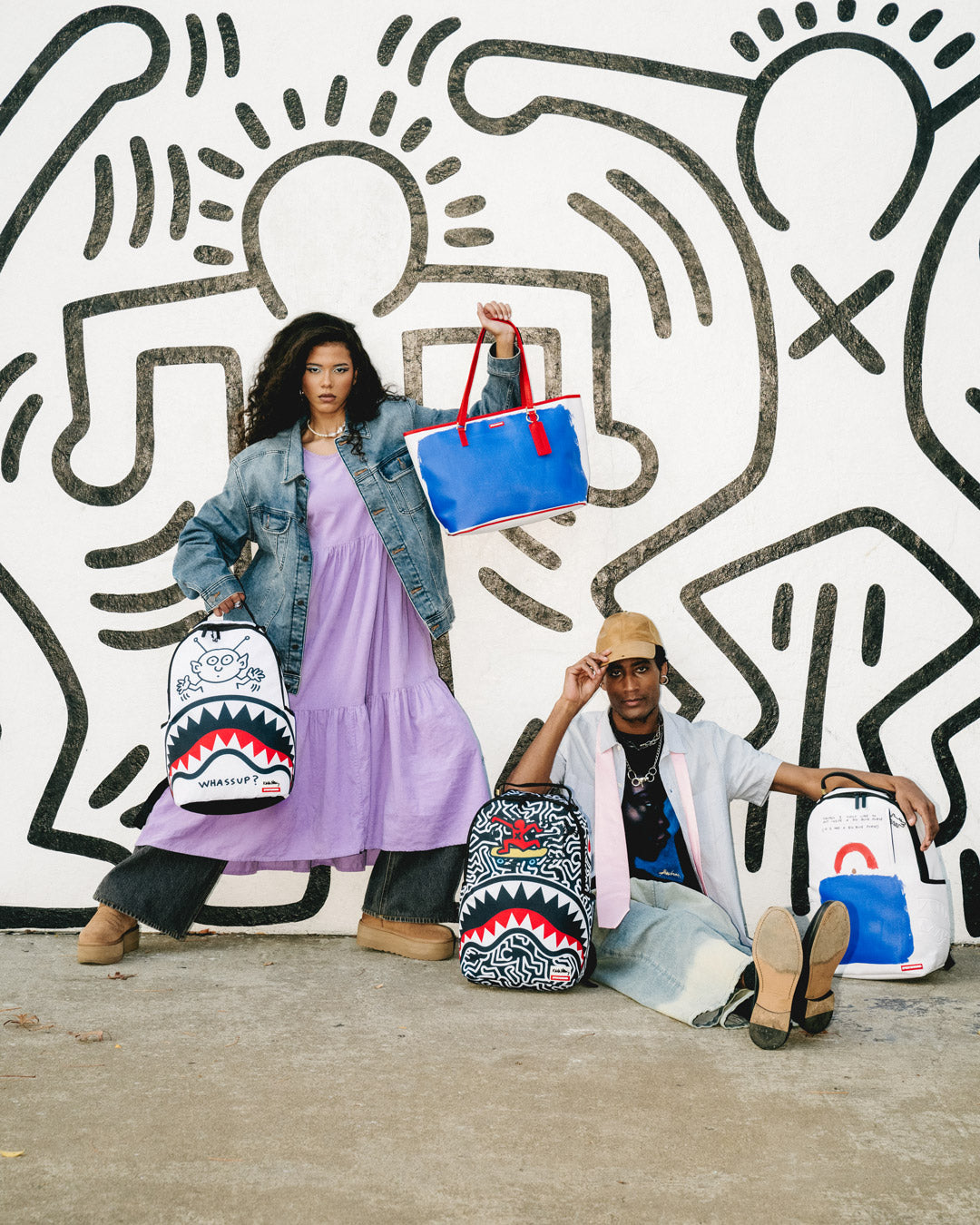 Sprayground Tote Bag with Keith Haring art, being carried over the shoulder