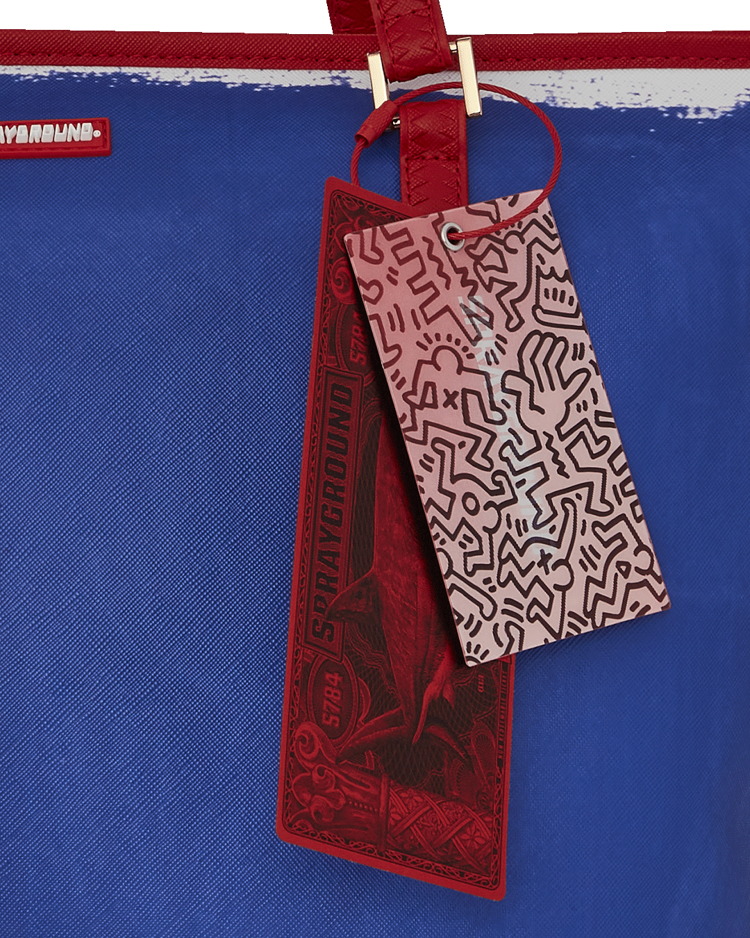 Sprayground Tote Bag with Keith Haring art, being carried over the shoulder