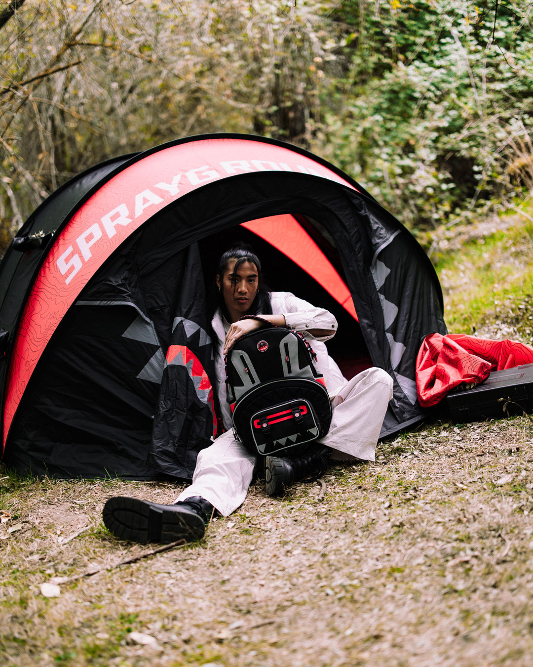 Folded easy setup tent packed in zip carry bag on gravel path