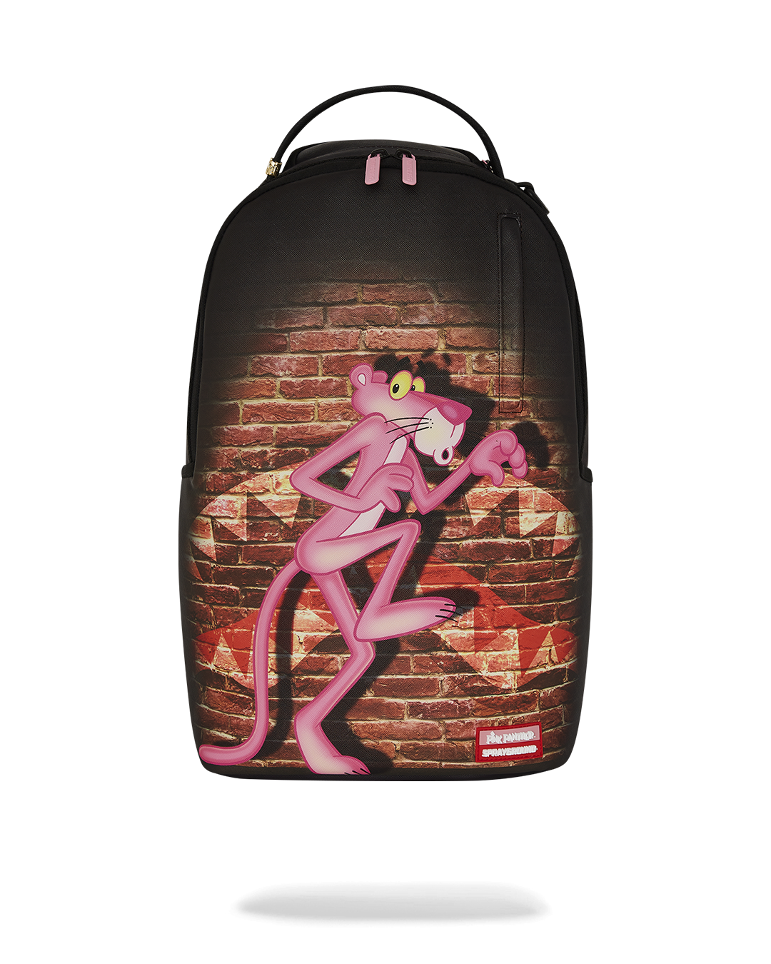 Close-up of gold zippers and metal Sprayground badge on designer backpack