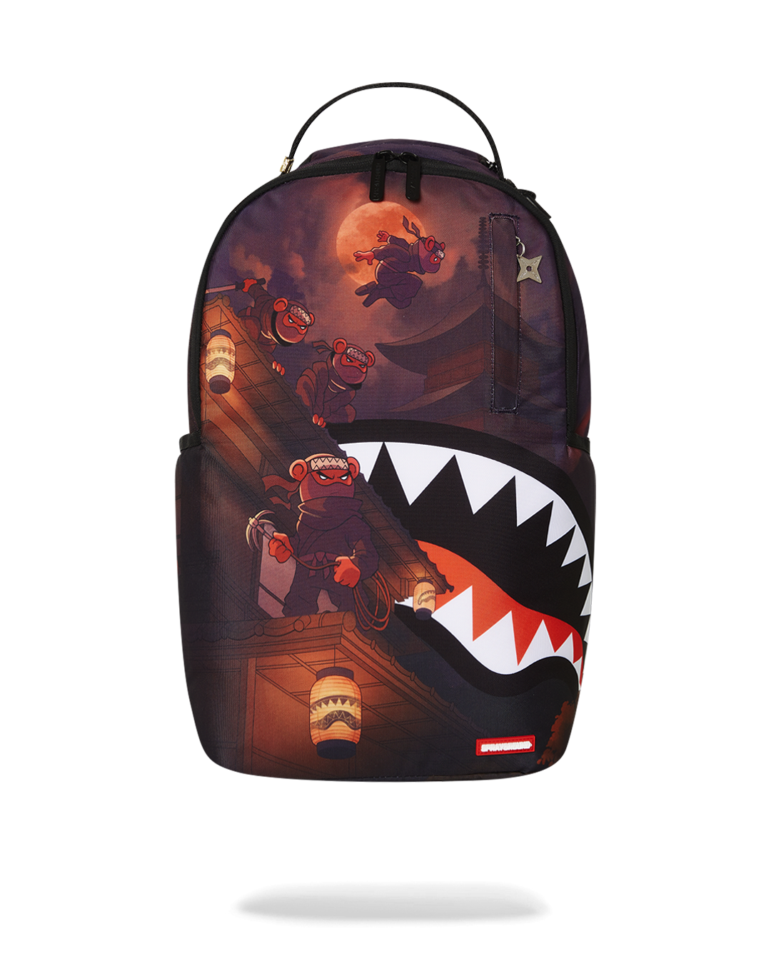 Front view of fashion backpack with ninja star zipper detail and gold accents.