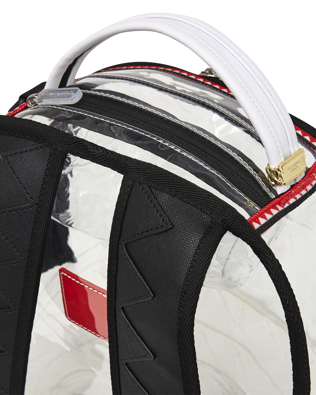 Clear Sprayground shark backpack showing front shark mouth detail and zippers
