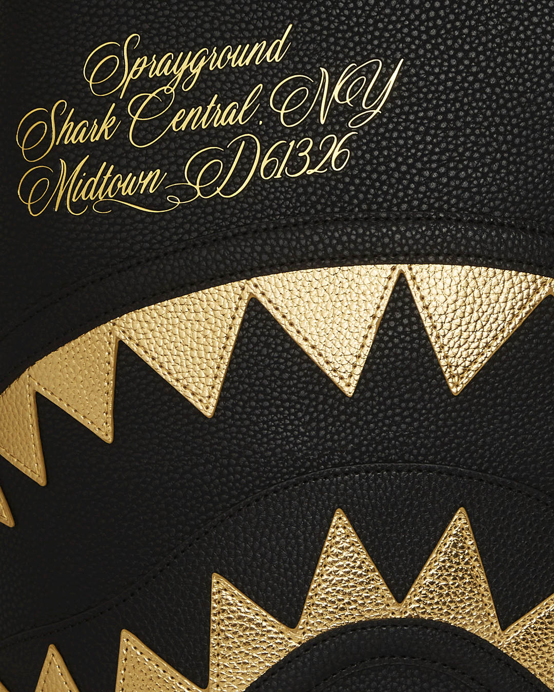 BAPE Shark backpack with faux leather finish and gold accents, interior view showing laptop compartment