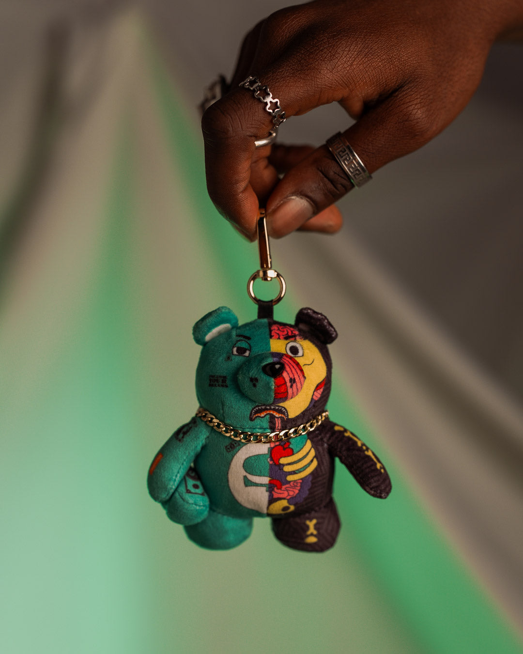 X-Ray bear keychain hanging from a stylish backpack.