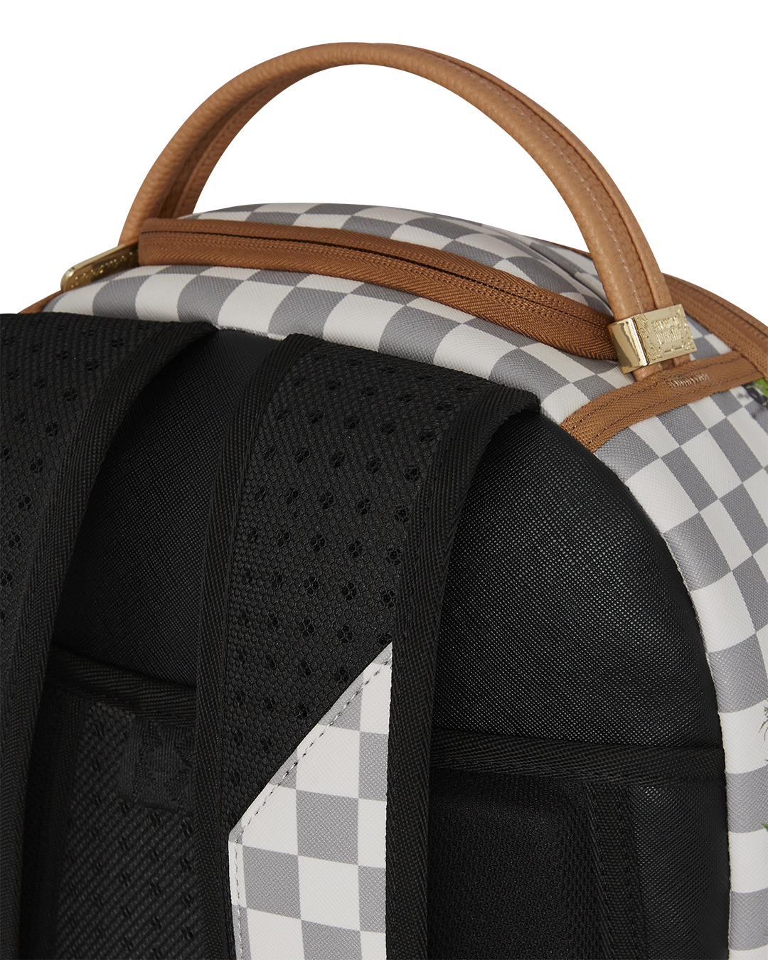 Front angle of pink Sprayground backpack with shark mouth design on city pavement