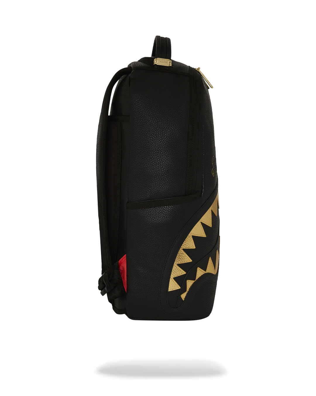 BAPE Shark backpack with faux leather finish and gold accents, side view showing adjustable straps