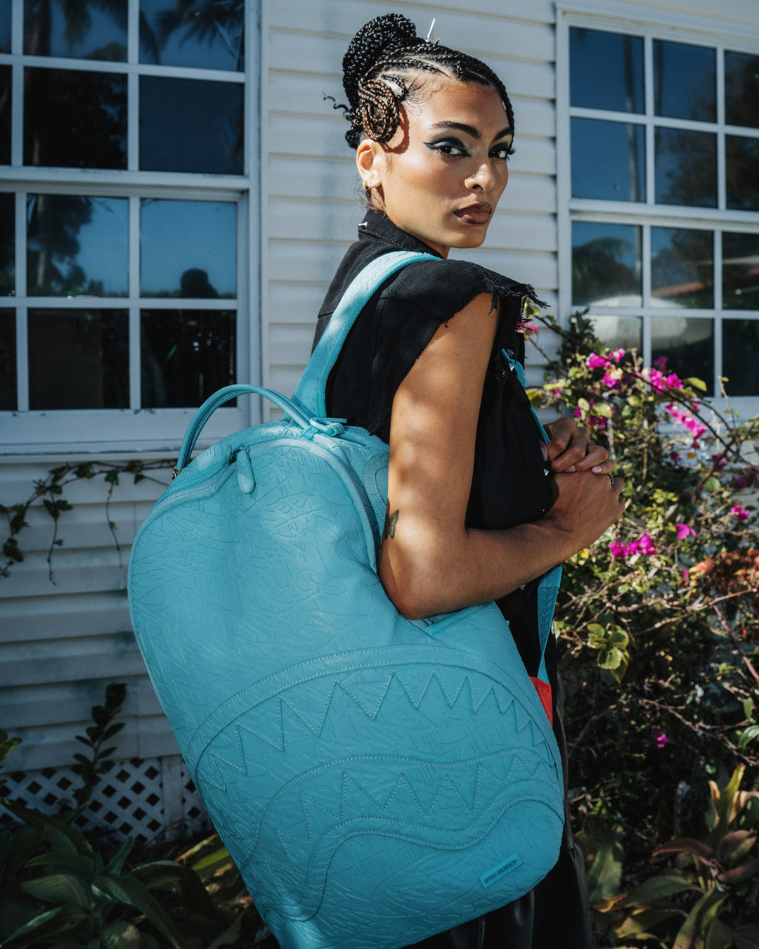 Top angle showing velour laptop and sunglass compartments in faux leather backpack
