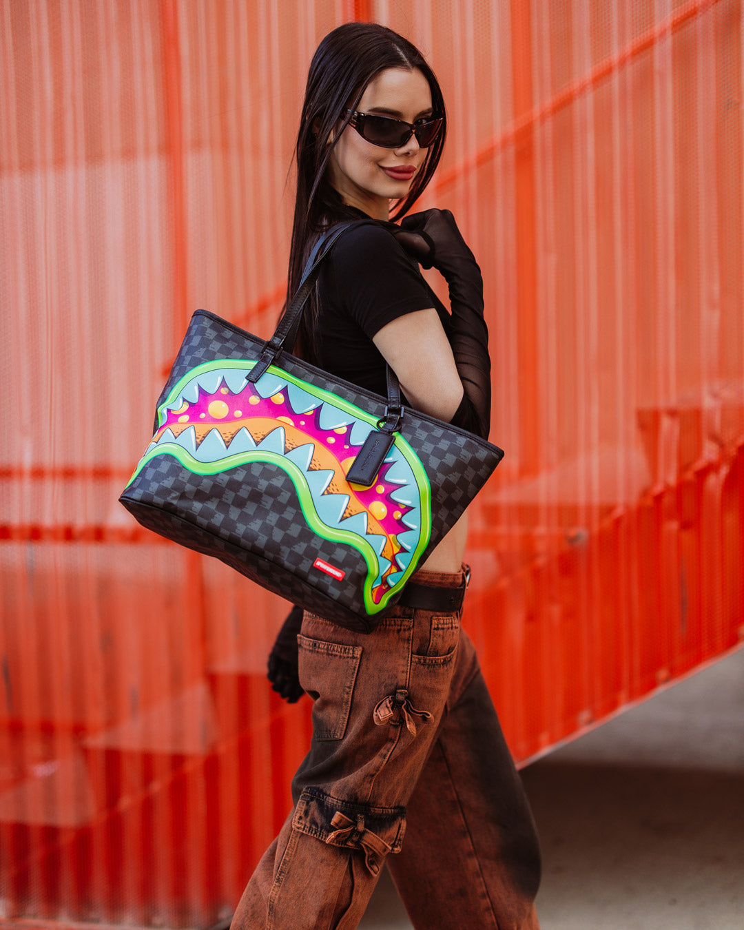 Sprayground tote bag being carried over the shoulder, showcasing its stylish design