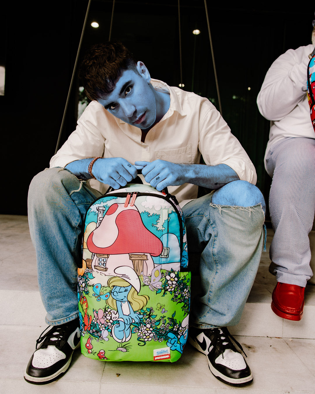 Smurfs Garden Adventure Backpack with front pocket and side compartments.