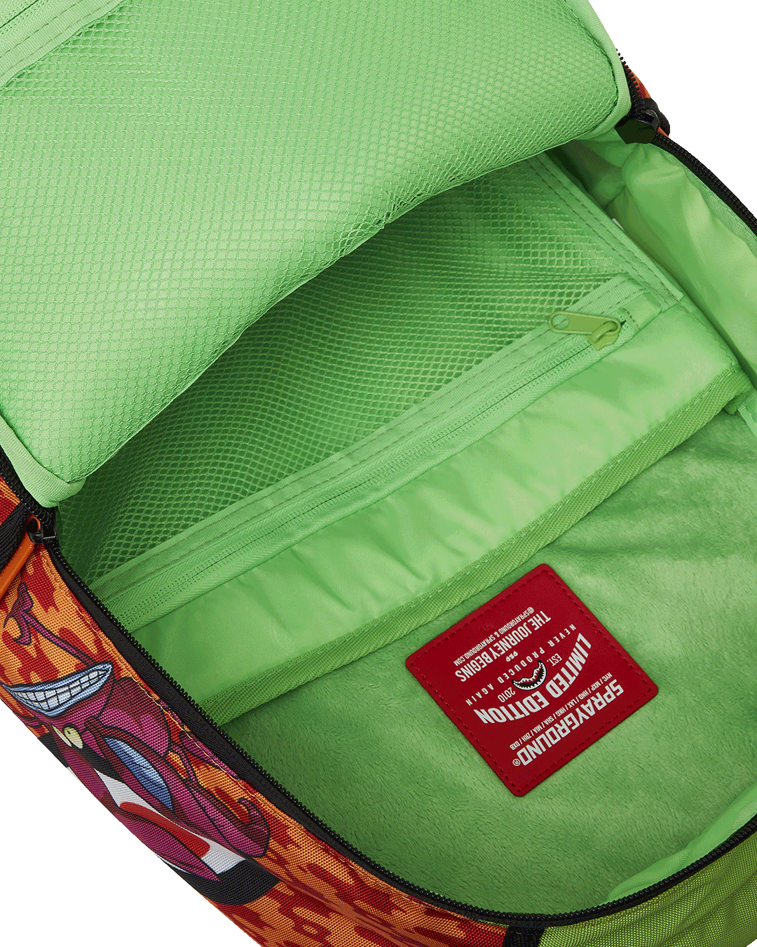 Side angle of the kids travel backpack placed beside a carry-on luggage piece.