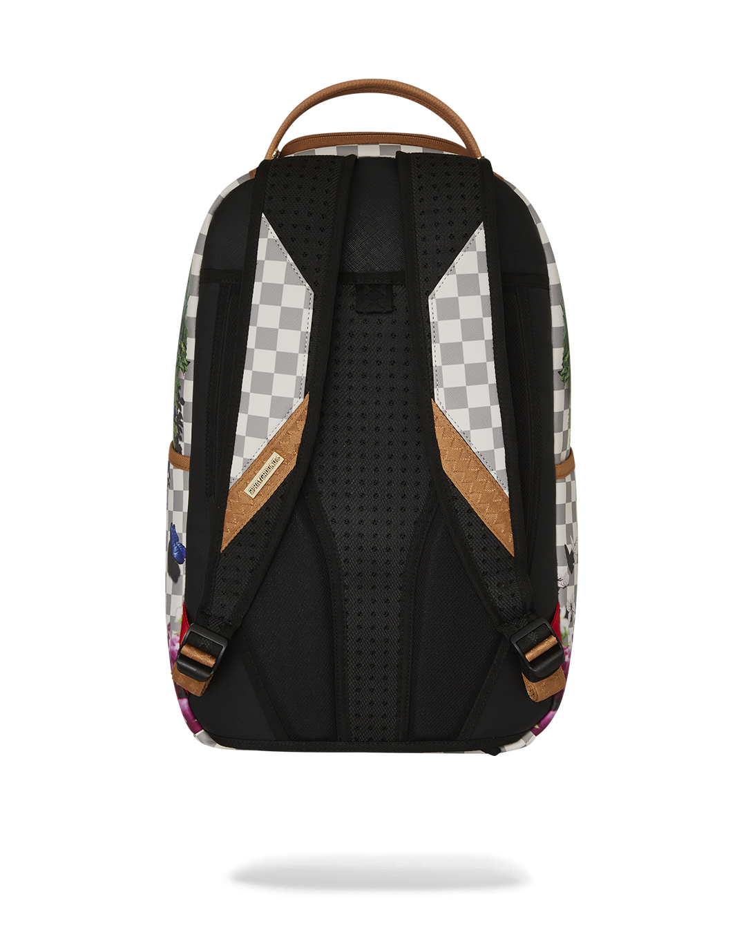 Front angle of pink Sprayground backpack with shark mouth design on city pavement