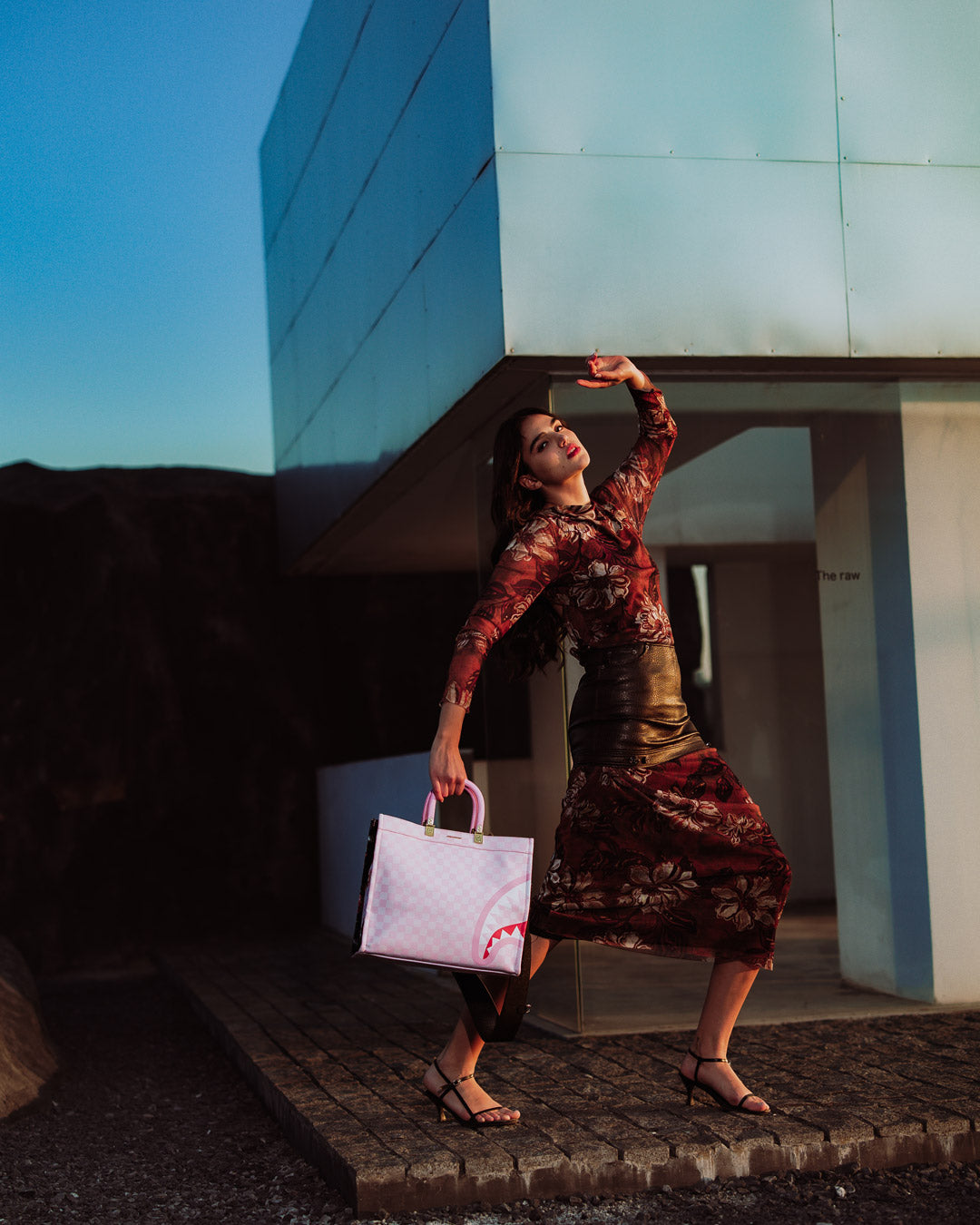 Cross-body strap attached to the printed tote bag for versatile wear