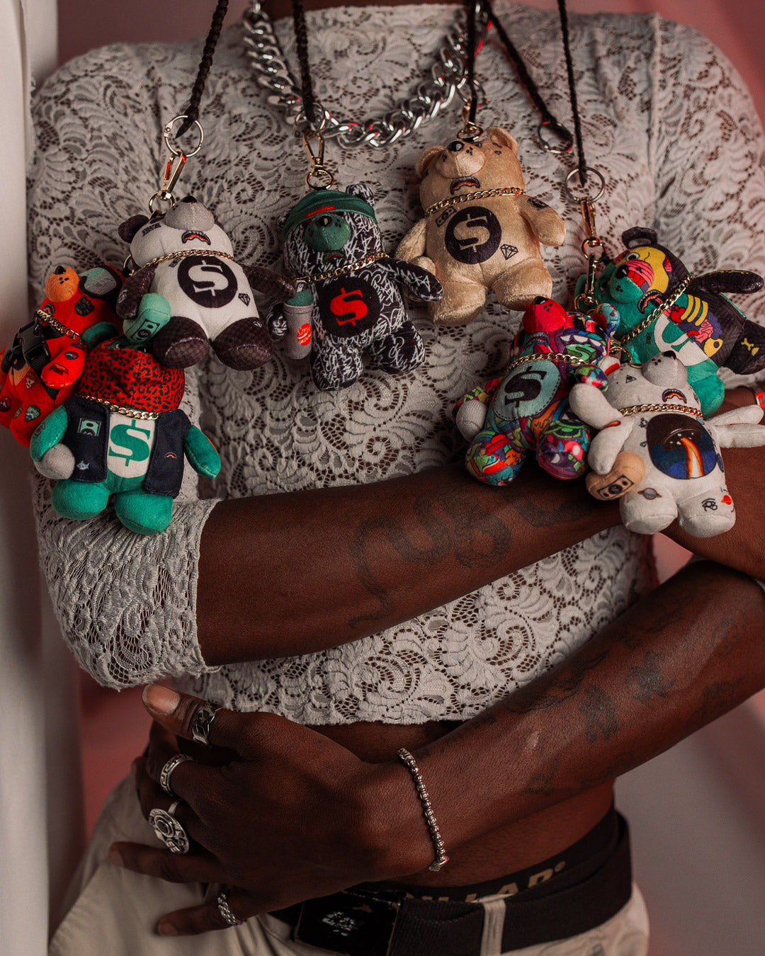 The plush bear keychain attached to a pair of keys, demonstrating its functionality.