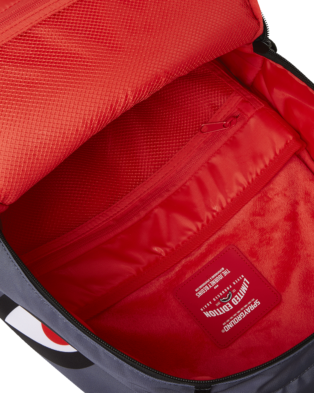 Close-up of the gold zipper and metal badge on the Garfield backpack