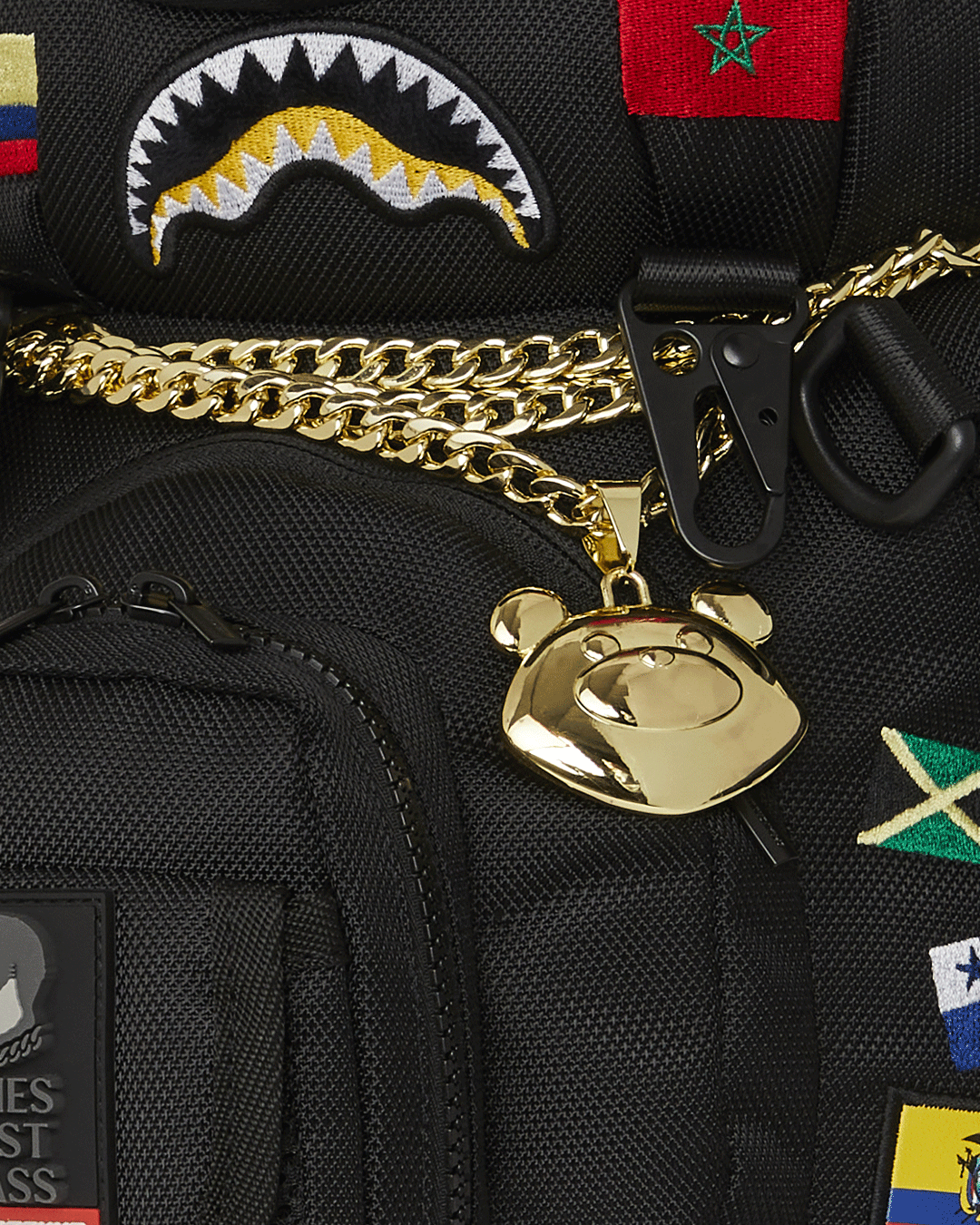Close-up of the embroidered teddy bear with flags, demonstrating craftsmanship and vibrant detail.