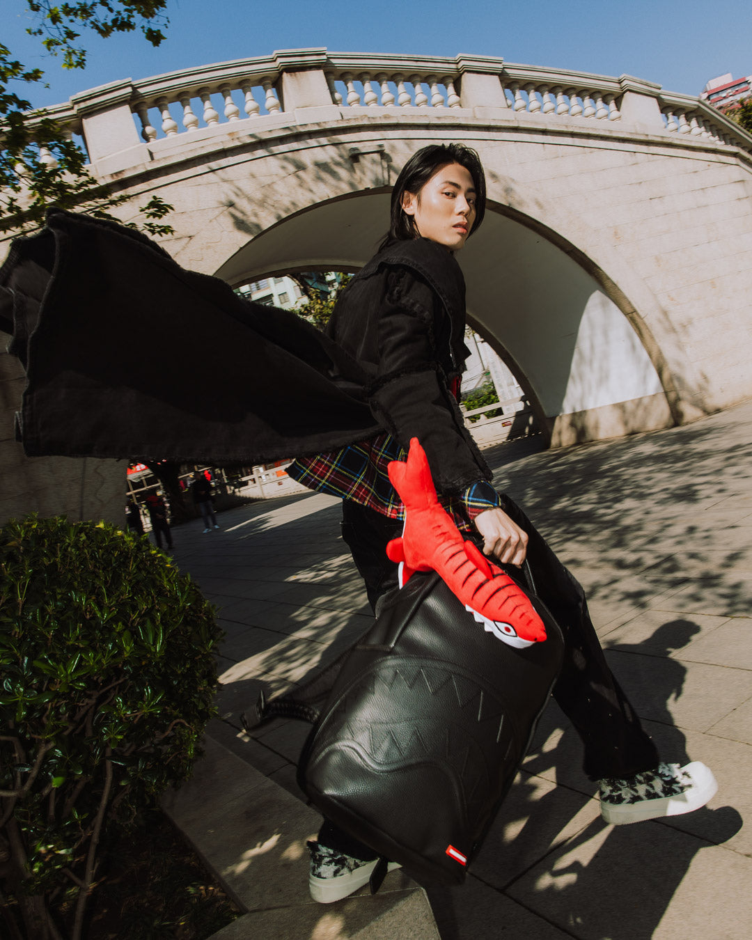 Front angle of fashion backpack showing shark design and metal zippers
