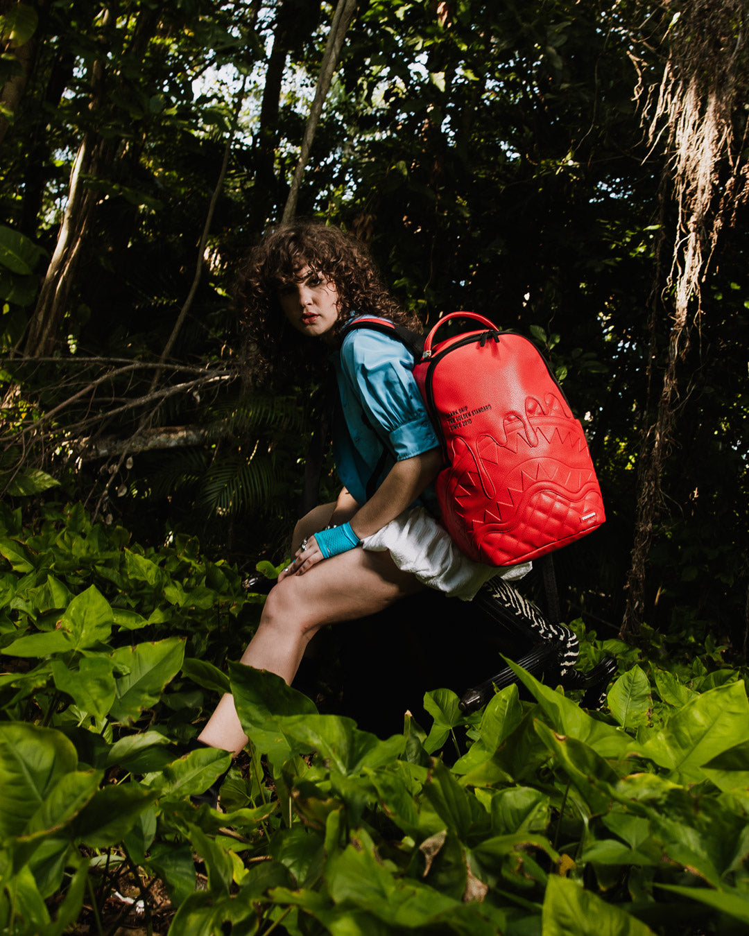 Open backpack showing velour laptop and sunglass compartments with organized mesh pocket.