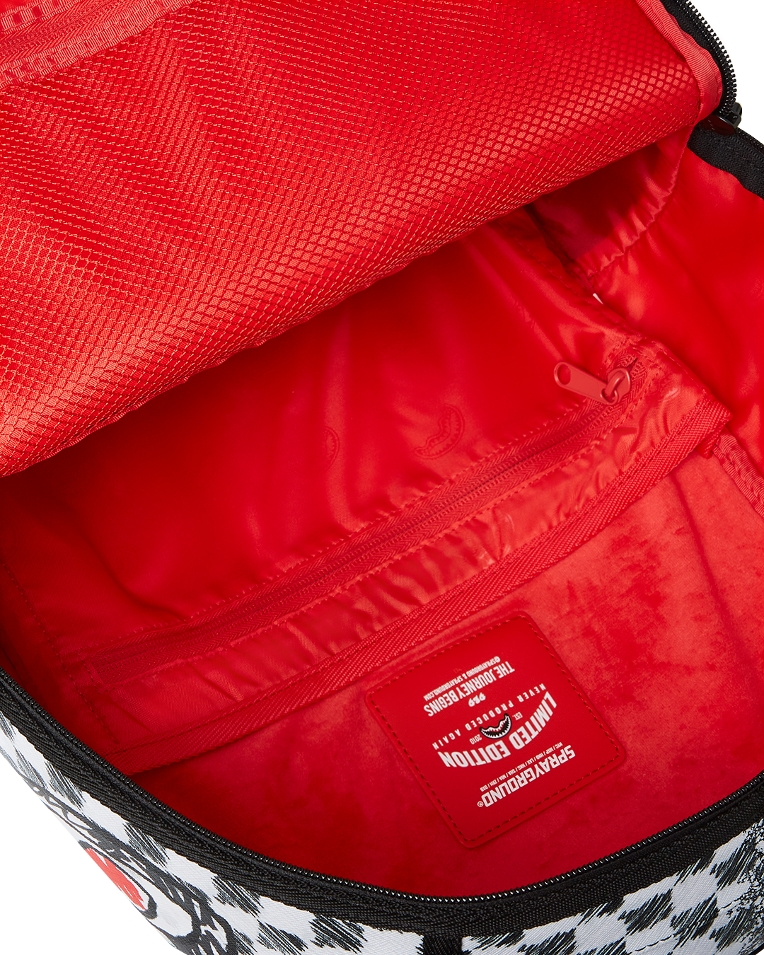 Interior view of the backpacks separate velour laptop compartment and mesh organizer pocket