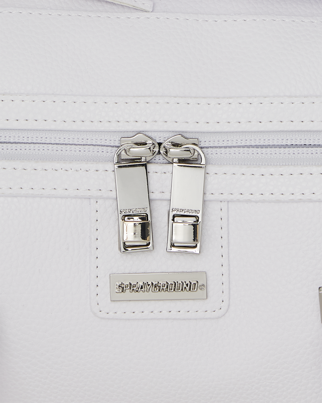 Close-up of the embossed sharkmouth design on the reflective duffle
