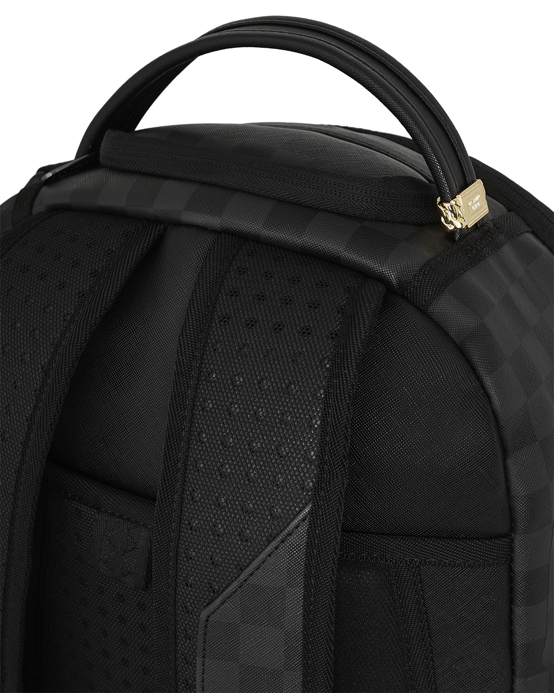 Close-up of the backpacks gold zippers and metal Sprayground Authentic badge