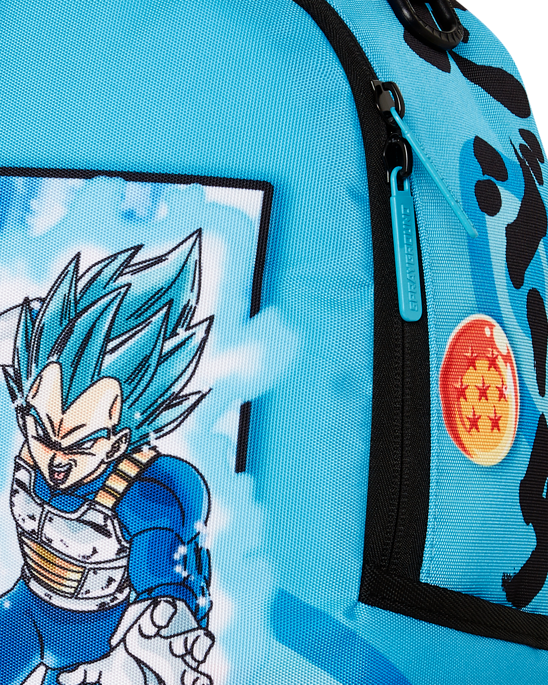 Close-up of the Sprayground backpacks metal Authentic badge and gold zippers with metal hardware.