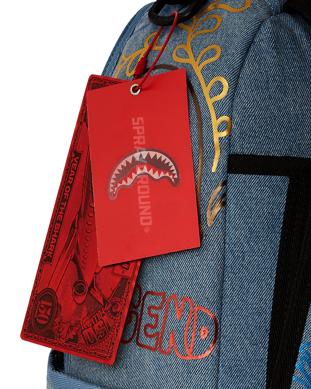 Front view showing gold zippers and denim texture on designer backpack