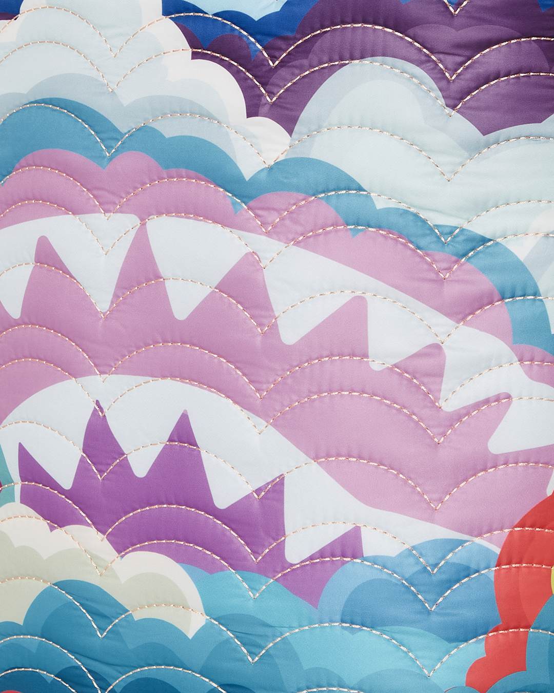 Rainbow quilted backpack worn over shoulders, showcasing cloud detailing and side pockets