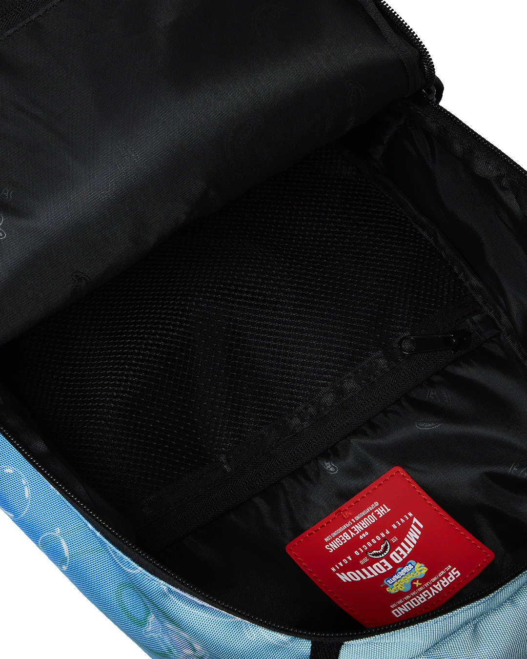 Side angle showing adjustable mesh straps and luggage sleeve