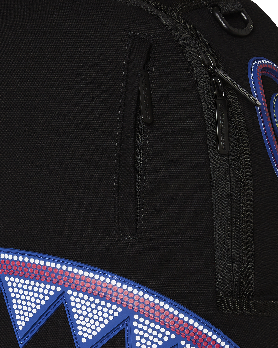 Side pocket detail showing Sprayground’s signature zipper design