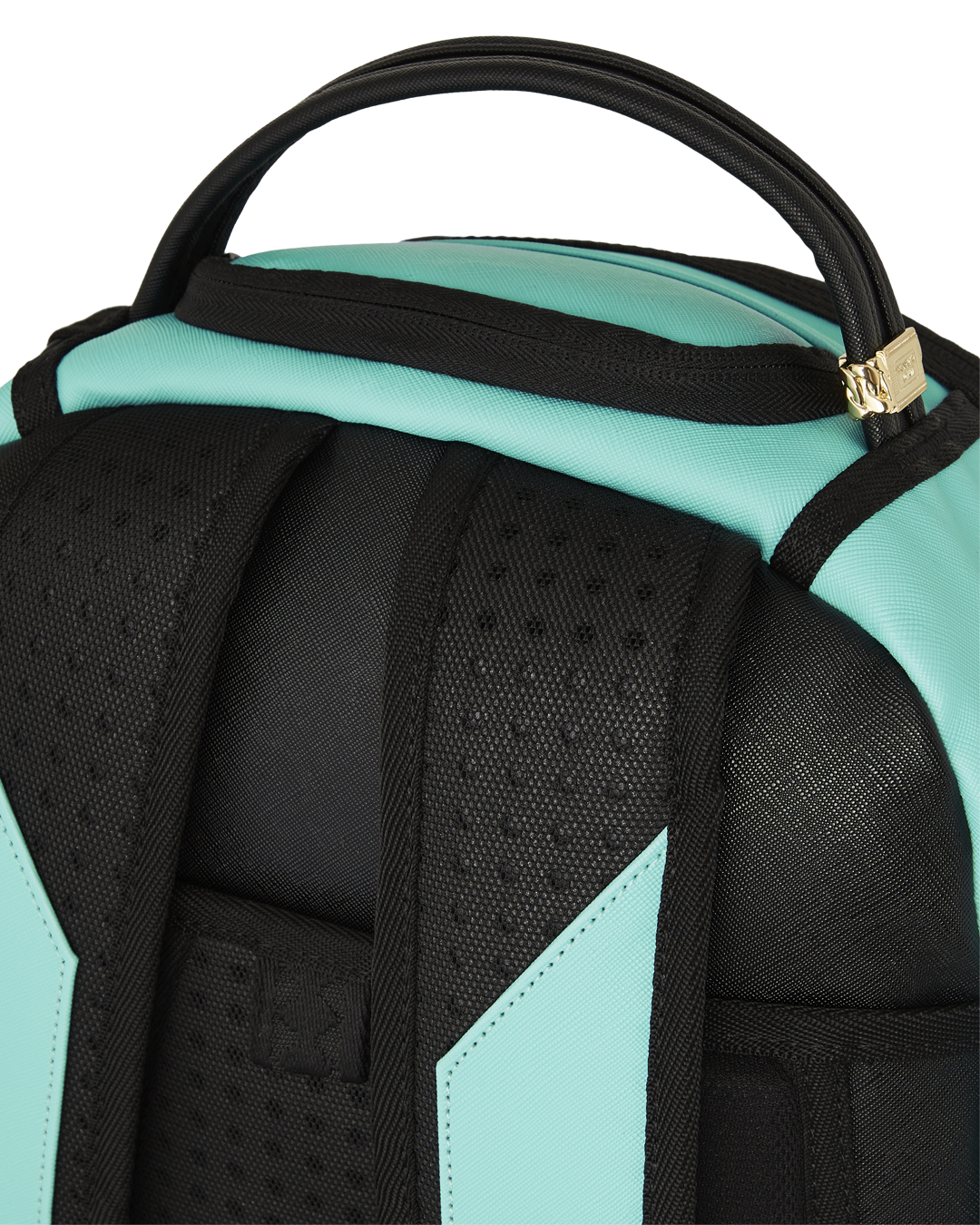 Close-up of faux leather texture and gold hardware on the backpack’s front zipper pocket.