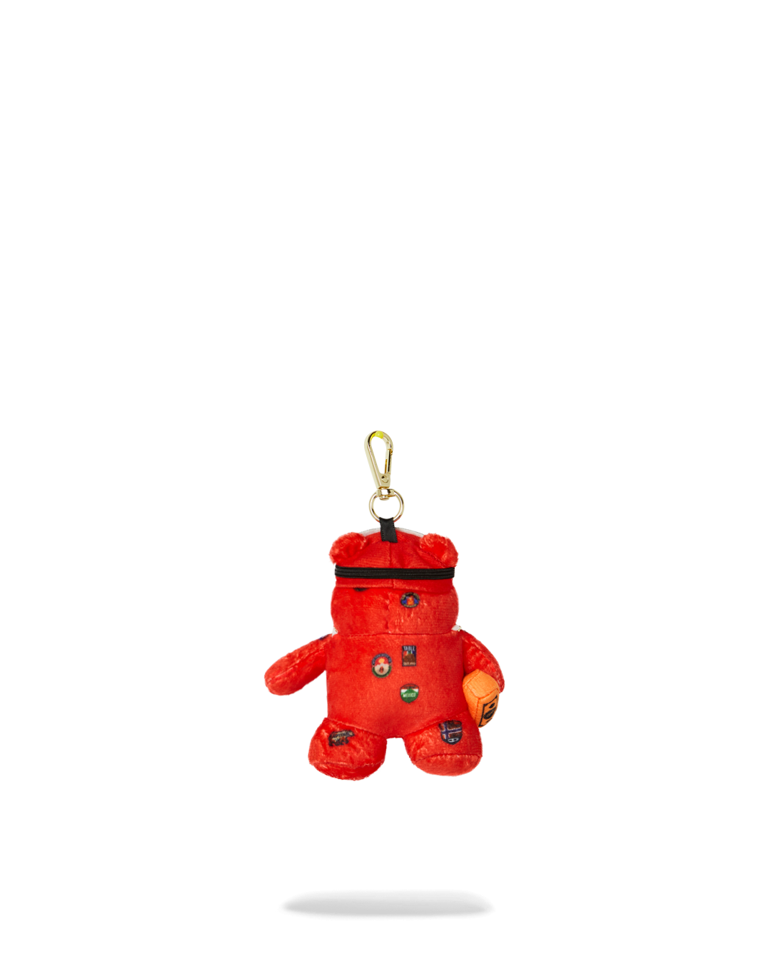 Bear-shaped plush keychain hanging from canvas backpack, suited for urban explorers