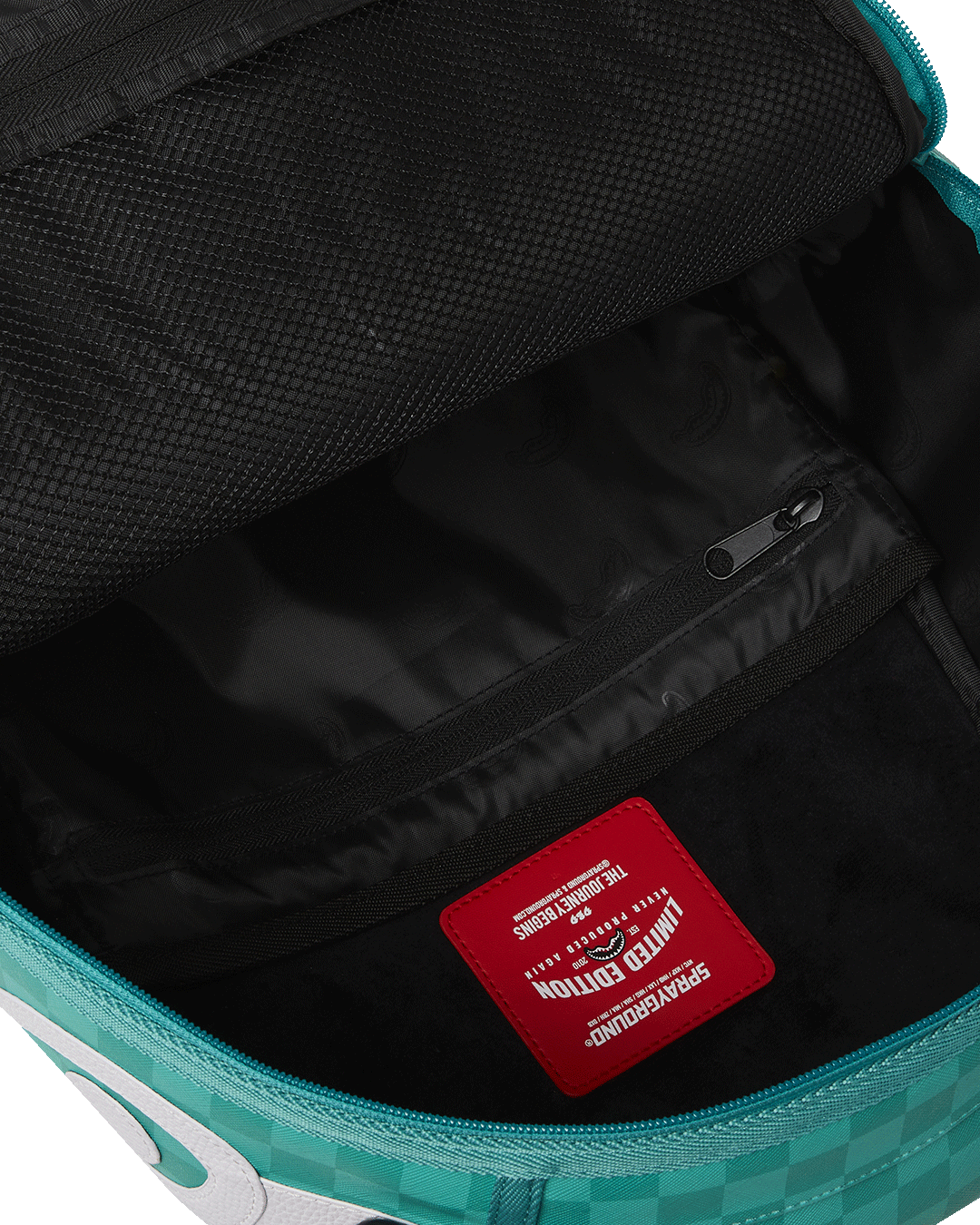 Ergonomic mesh back padding of the Sharkmouth backpack, designed for comfort during long wear.