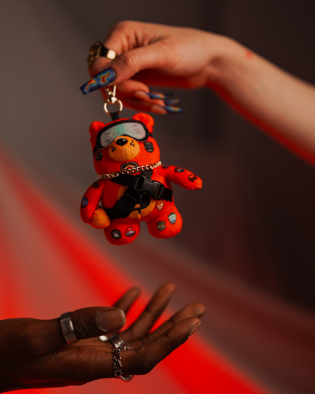 Close-up of plush bear keychain with tiny goggles and hat, best for travel lovers