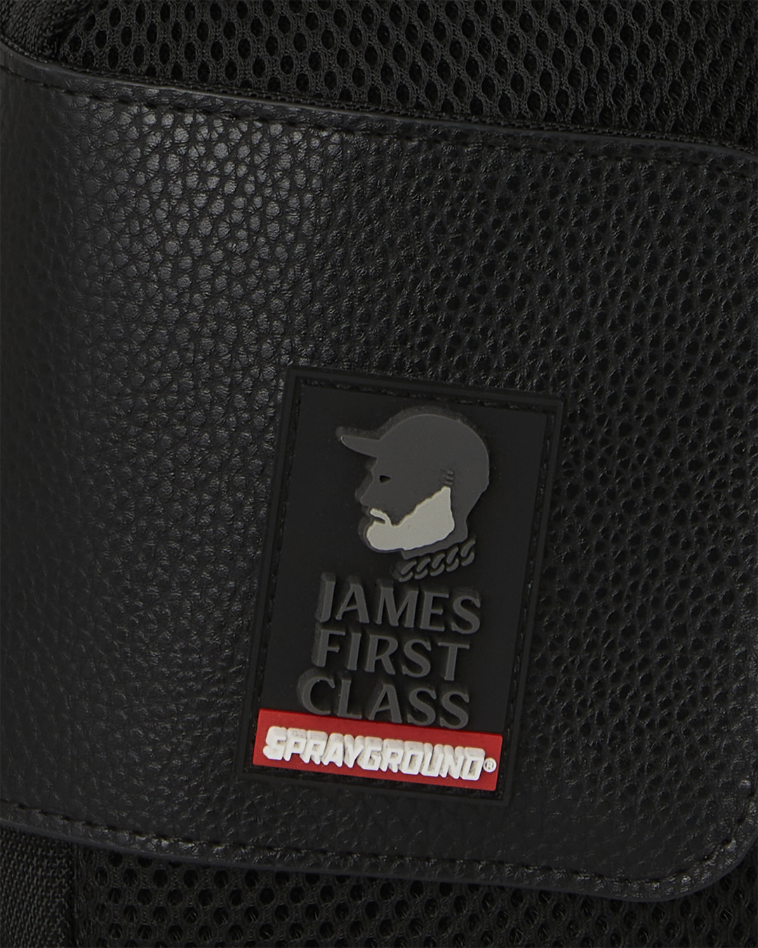 Detail of the faux leather trims and gold zippers on the duffle bag