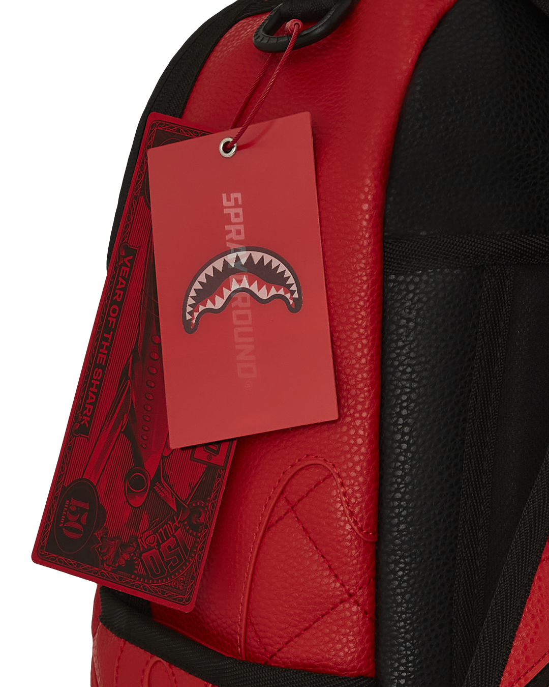 Front view of the embossed faux leather backpack with gold zippers shown against a city backdrop.