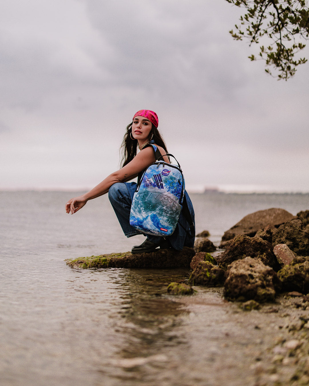 Sprayground NASA Collaboration Limited Edition Laptop Backpack being used by a traveler at an airport, highlighting its travel-friendly features.