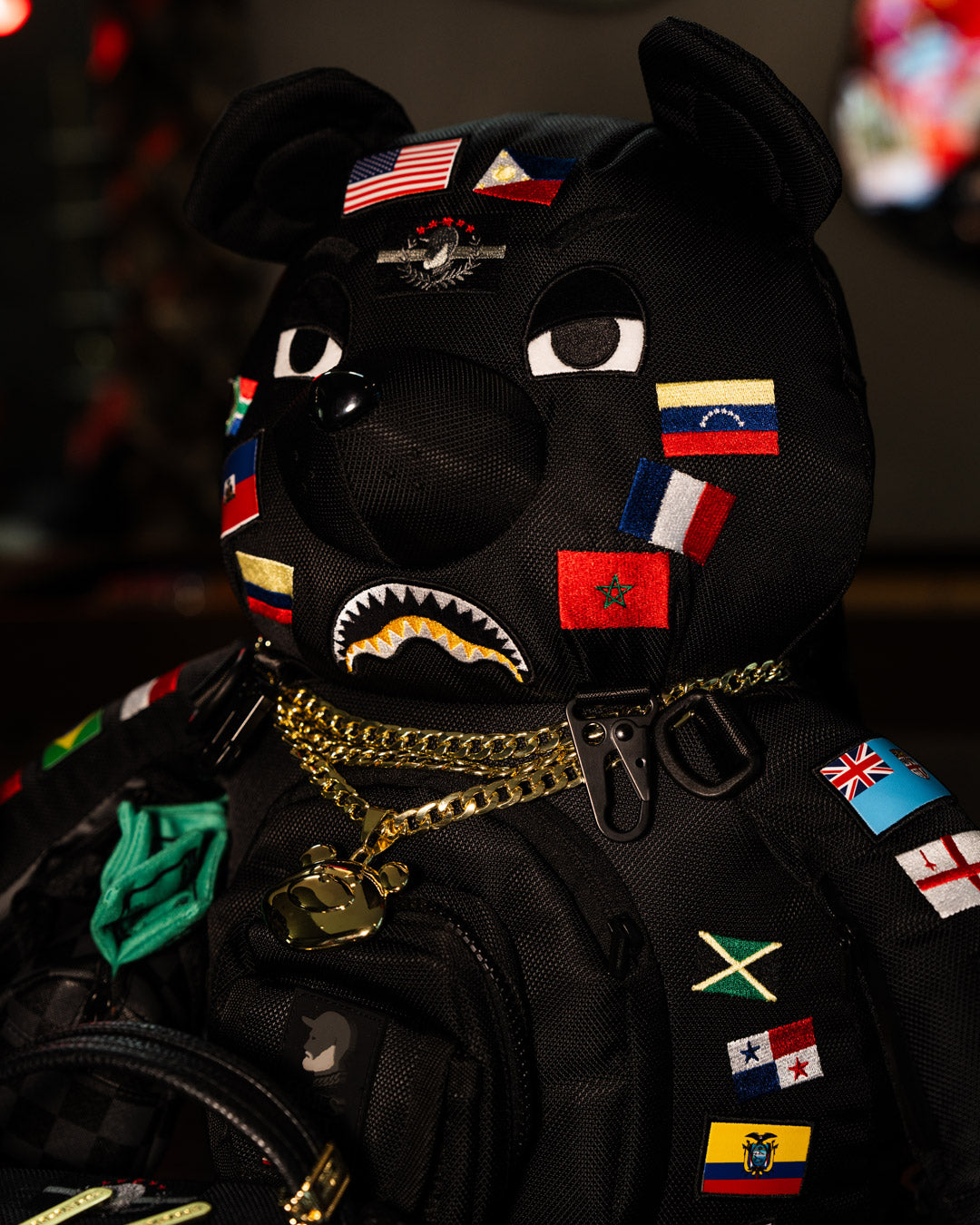 Close-up of the embroidered teddy bear with flags, demonstrating craftsmanship and vibrant detail.