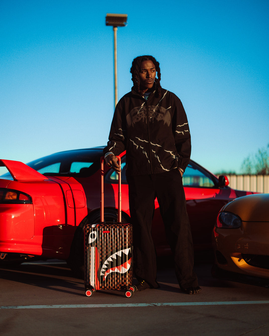 SHARKS IN PARIS GT polycarbonate carry-on luggage shown in travel mode with extended handle