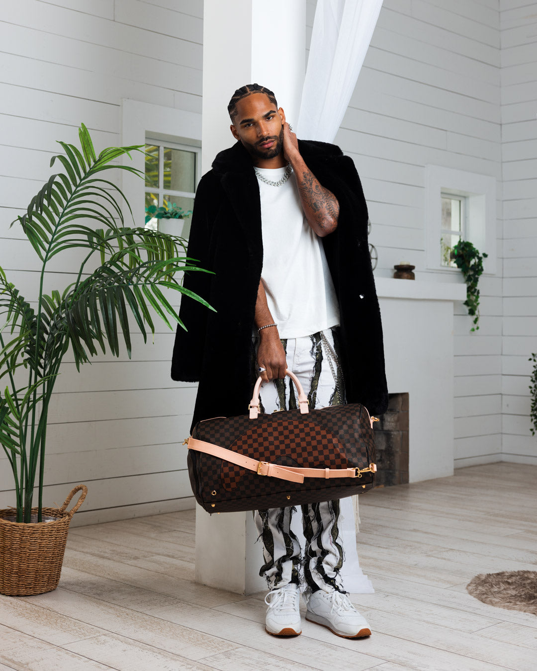 Front view of the faux leather rolling duffle bag in an outdoor setting.