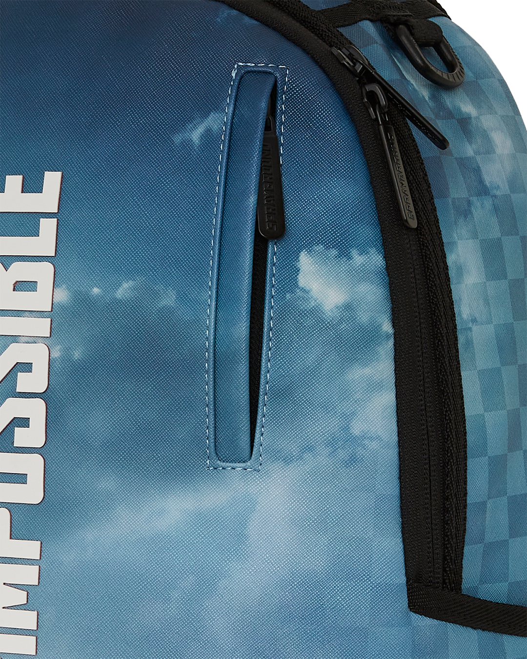 Close-up of gold zippers and faux leather finish on small backpack
