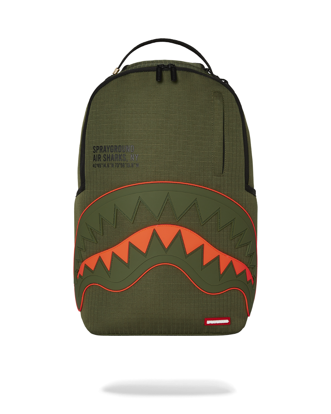 Closeup of shark backpack front showing rubber mouth and gold zipper